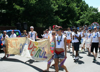 Students marching holding a gay pride banner for DePaul University