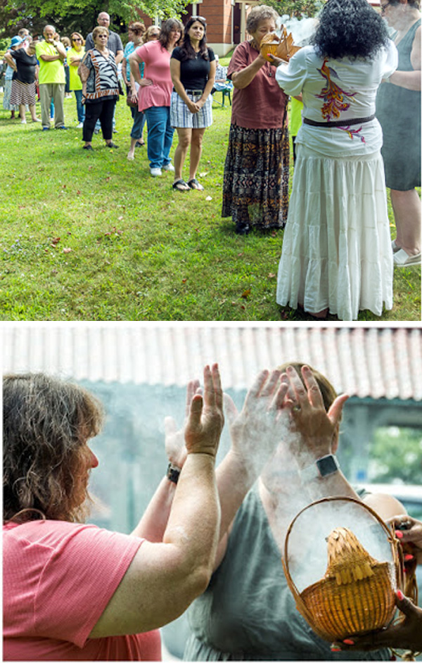 people line up to receive a native american incense blessing