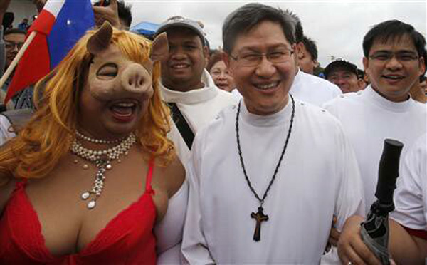 Cardinal Luis Tagle with an immorally dressed protestor