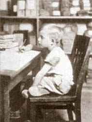 A black and white photograph of a boy with bad posture