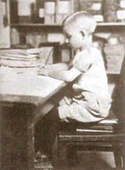 A black and white photograph of a boy with good posture