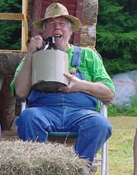 A hillbilly drinking out of a jug