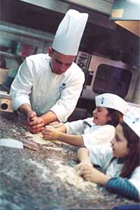A chef teaching children to cook