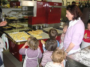 French pre-schoolers sampling pastries in a bakery