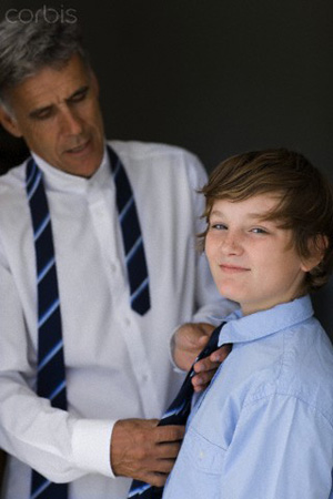 A Father teaches his son to tie tie