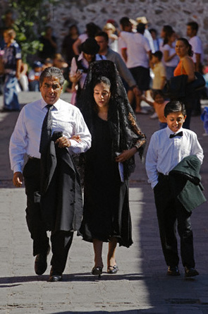 A well dressed Traditional Mexican family during a procession