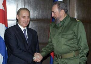 Putin shaking hands with Fidel Castro