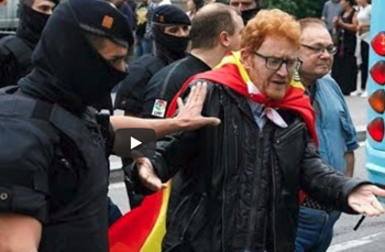 Policeman shoving an elderly Catalon voter