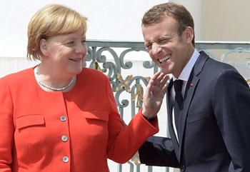 Merkel smiling with Macron