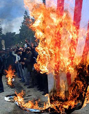 Protesters burn an American flag
