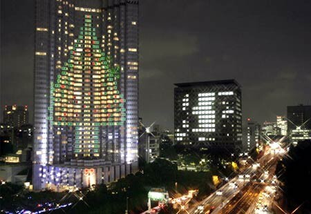 A building lit up with a Christmas tree design in Tokyo