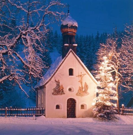 A small snow covered Church with a Christmas tree in Germany