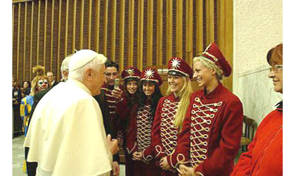 Benedict speaking with circus performers