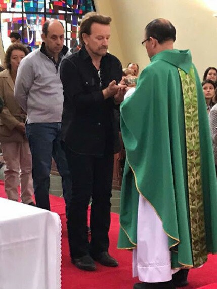 Paul David hewson, a.k.a. Bono, receiving Comunion in the hand in Colombia
