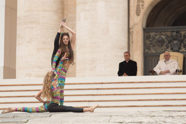 Two women in skin tight leotards perform suggestive dances before Pope Francis