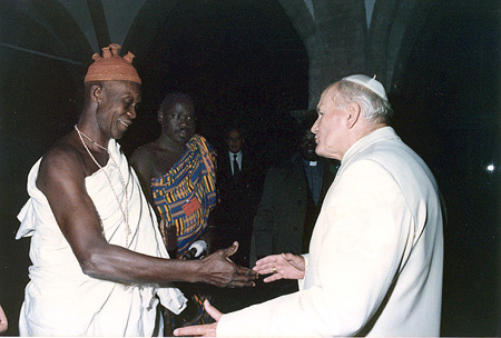John Paul II shaking hands with a voodoo priest