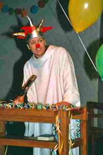 A clown acolyte giving a speech