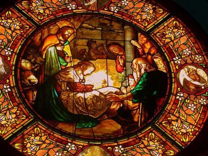 A stained glass window depicting the nativity