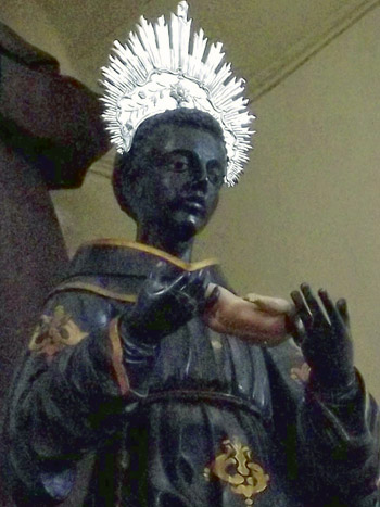 A statue of st. anthony of carthage holding the Christ Child