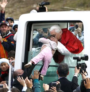 Benedict XVI kisses babies for the public