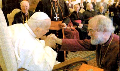 Pope kisses the hand of Anglican leader