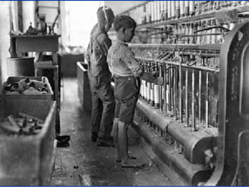 Black and white photograph of boys workin in a factory