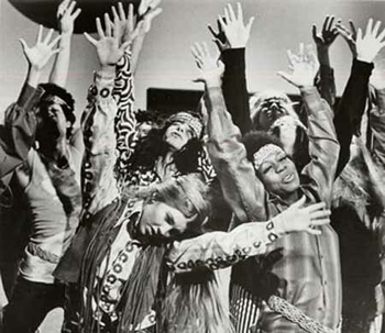 Hippies throwing their hands up in the air